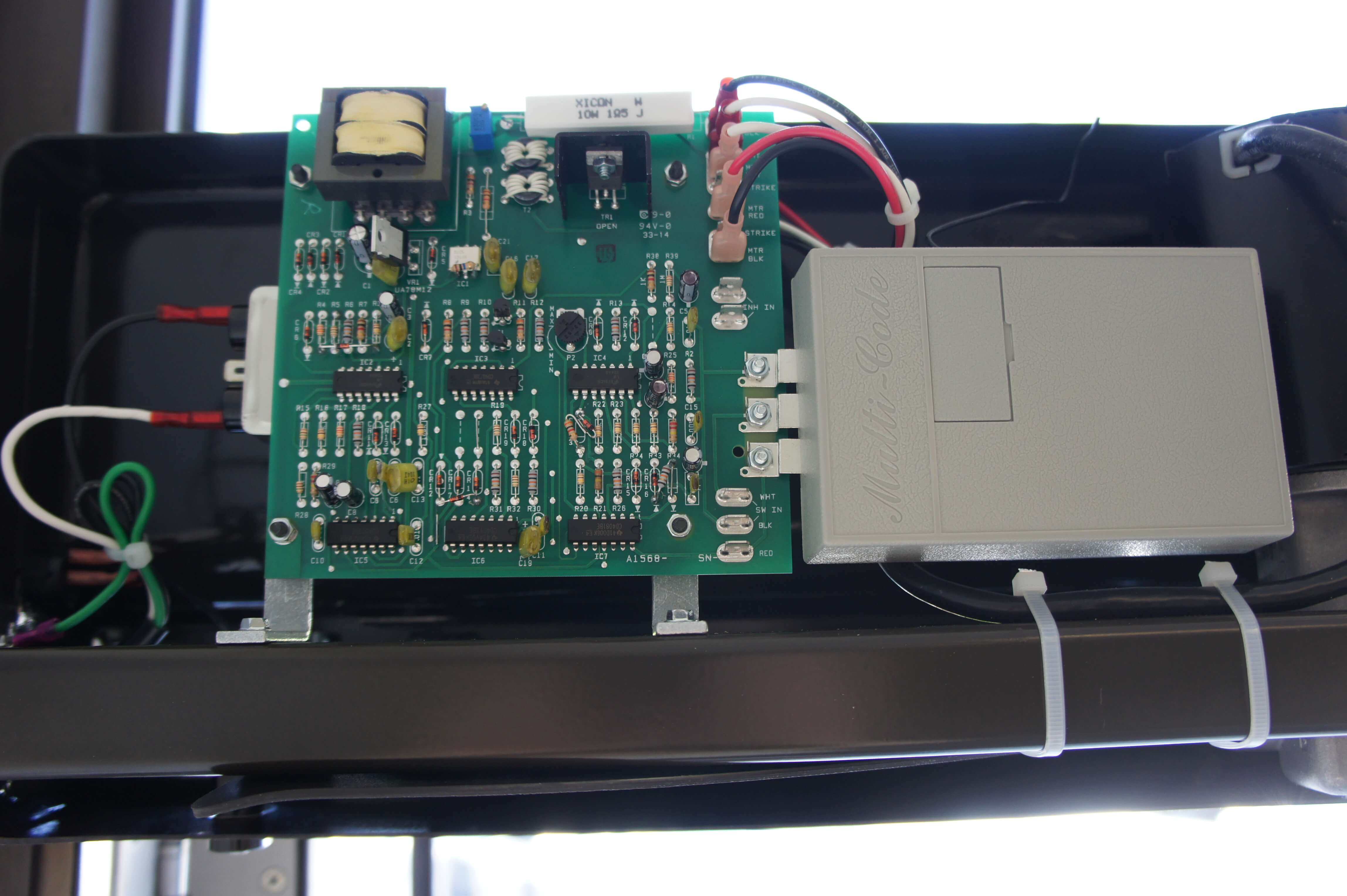 Inside of the Model 4300 Power Access automatic door opener, showing the main PC board and wireless receiver