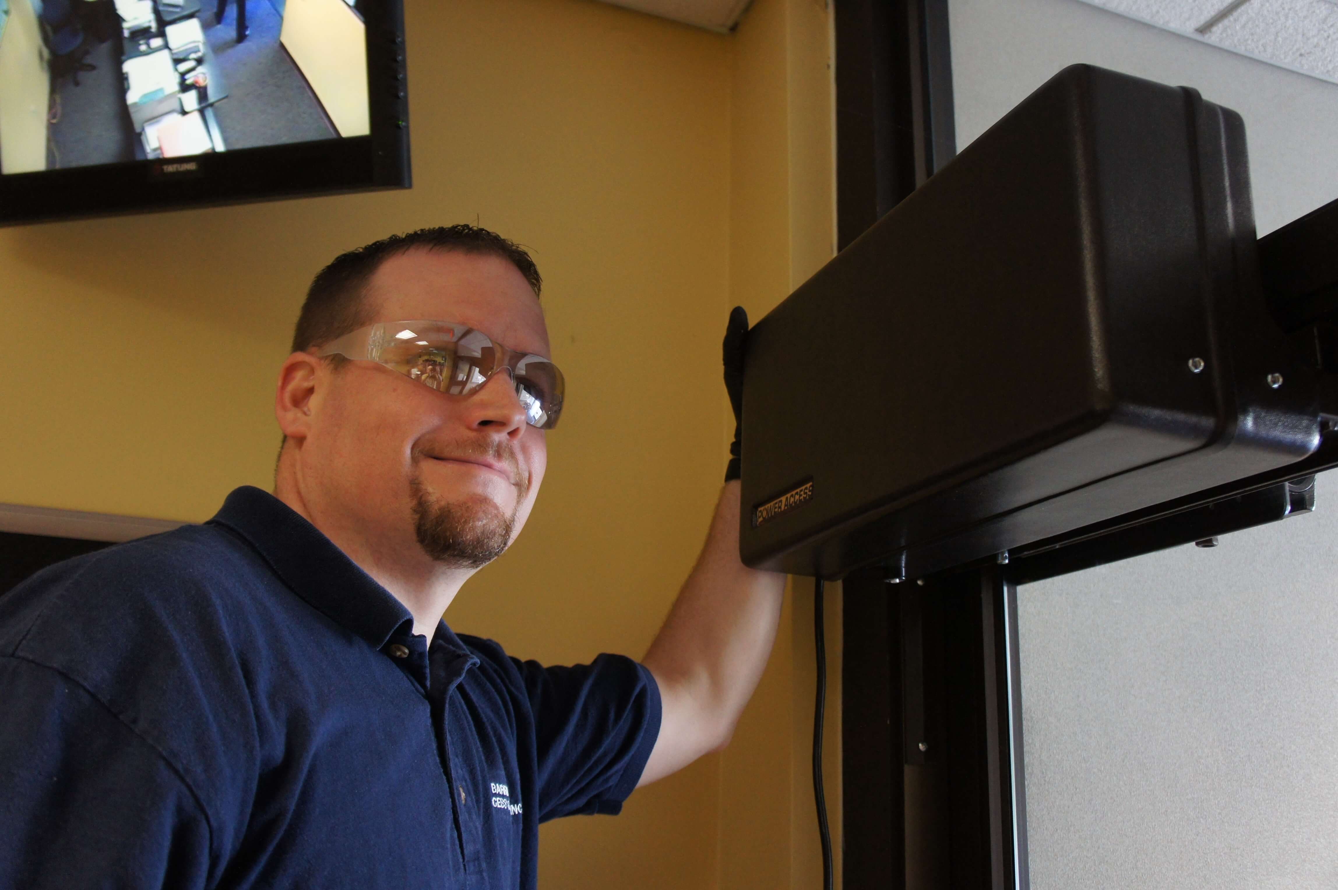 Man happy after a successful installation of a Model 4300 Power Access automatic door opener