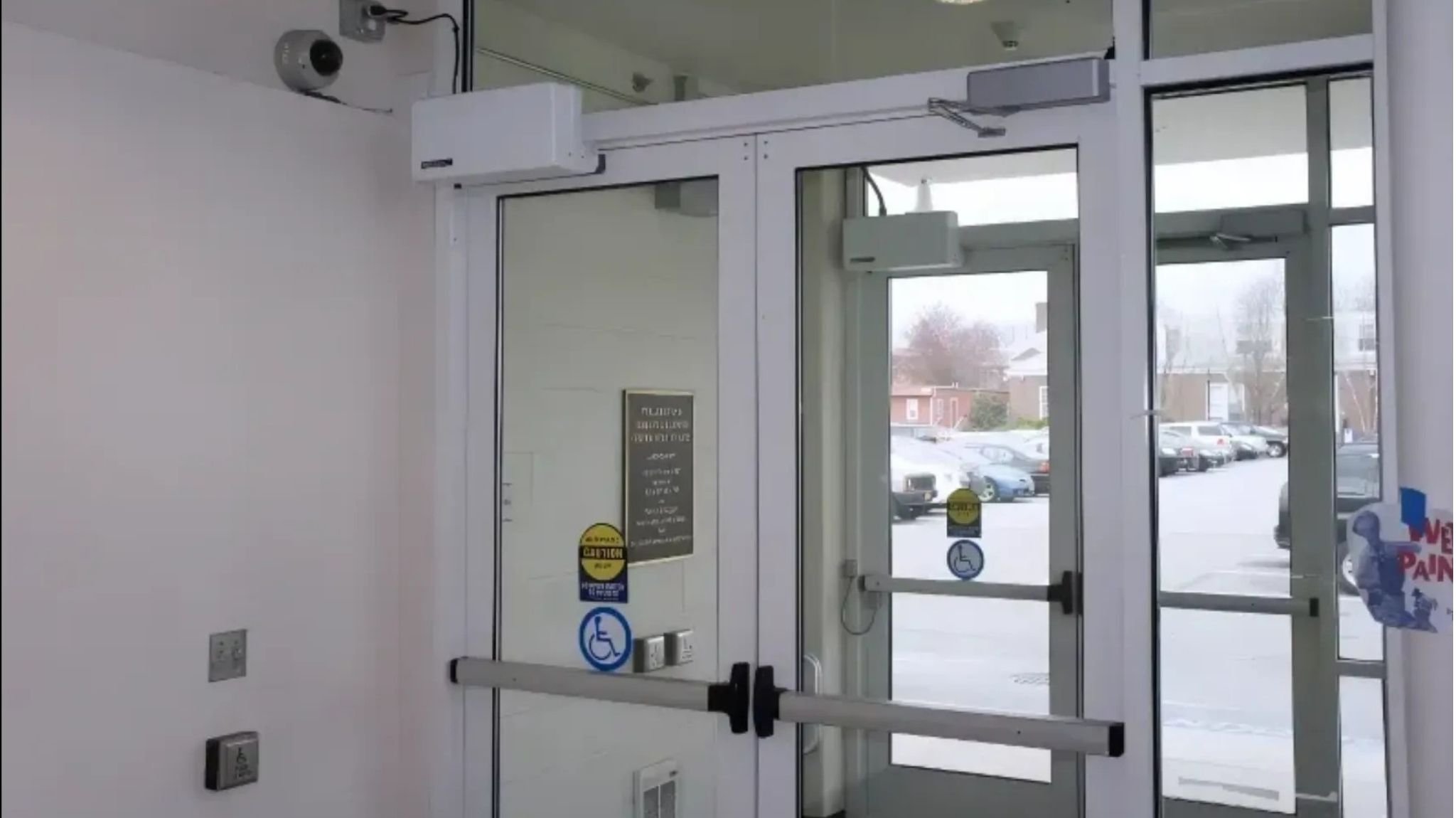 Model 4300Ls painted white on vestibule doors with push plates and accessibility stickers_16-9