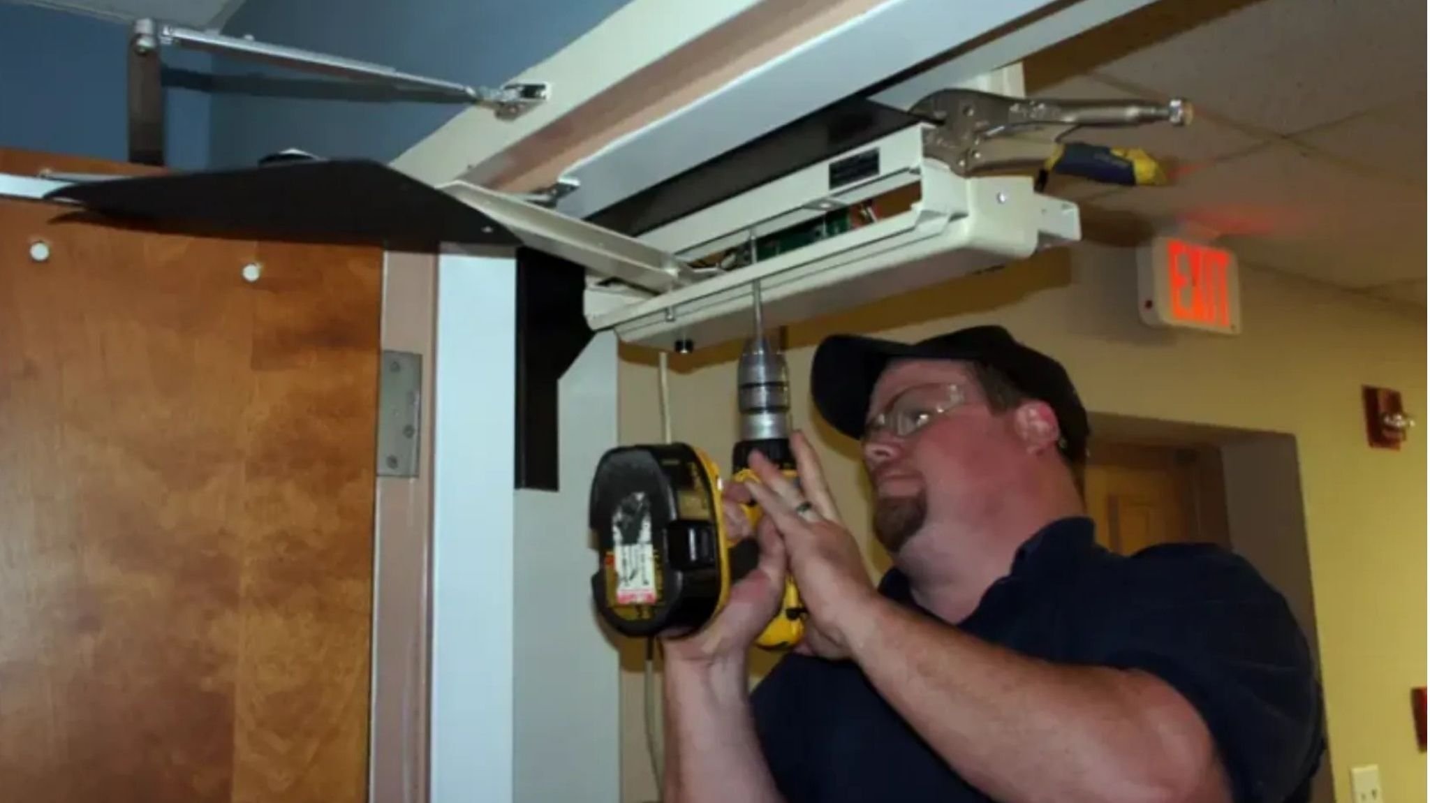 Model 4300XR automatic door opener being installed by a man on an interior door