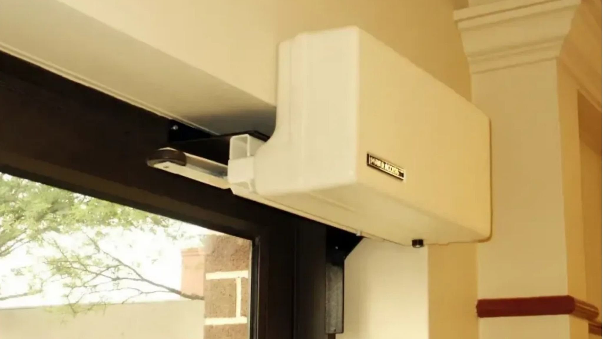 Up close of a Model 4300XR automatic door opener installed on an exterior-facing door