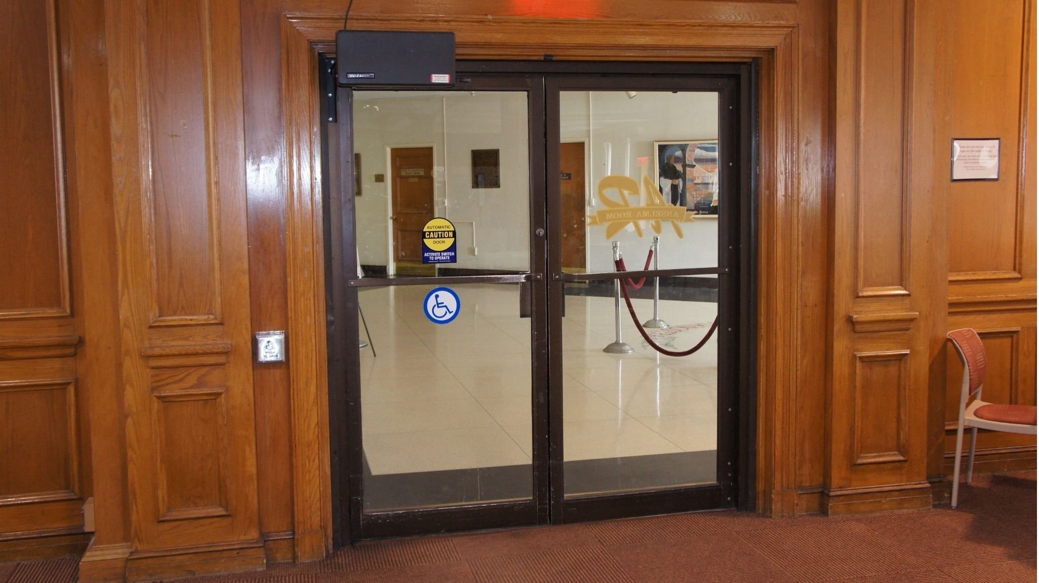 Model 4310L automatic door opener installed on a conference room door